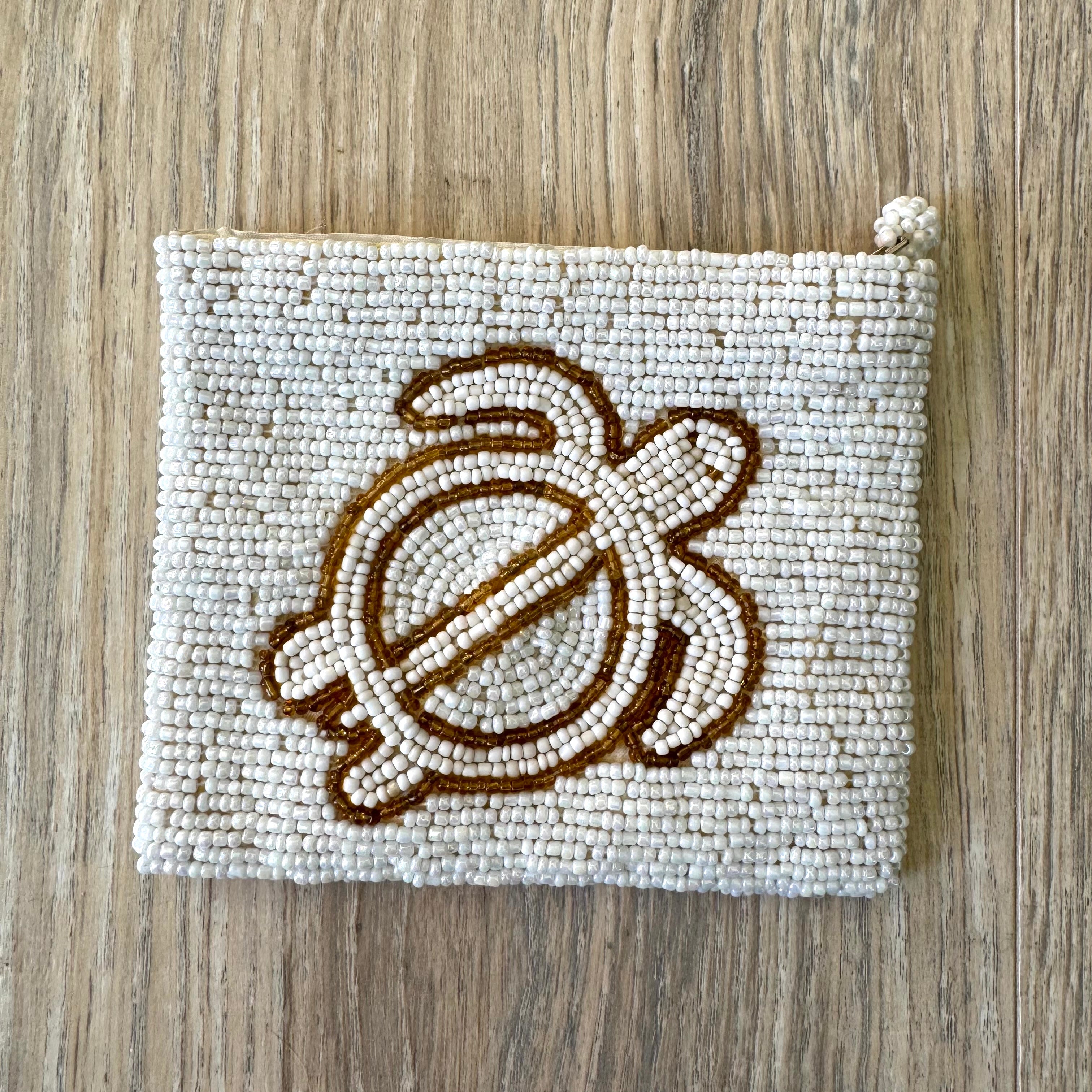 Reverse side of vintage white seed bead coin purse showing full bead coverage and knotted zipper pull