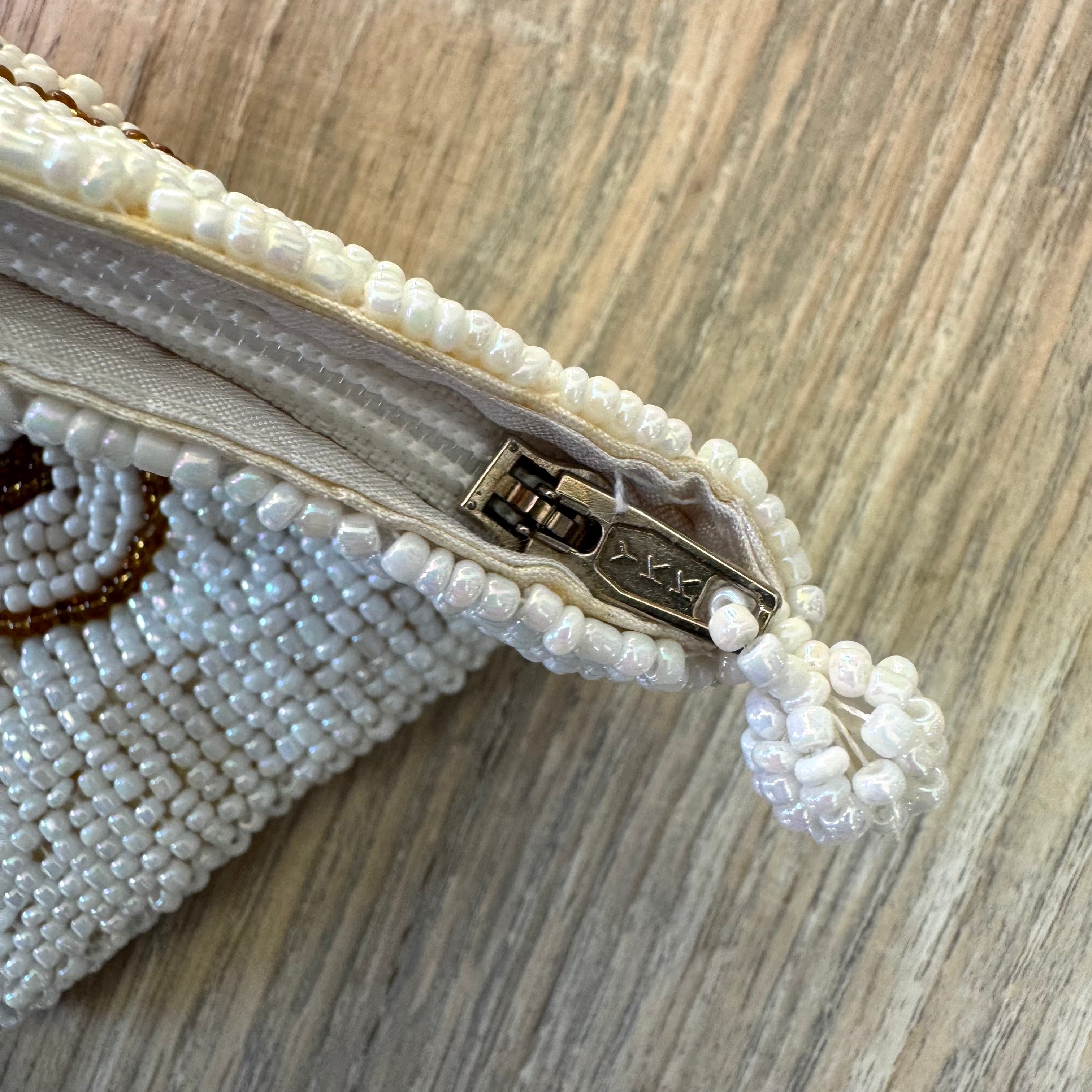 Close up of YKK zipper and white seed bead border on vintage coin purse